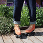Chuffed Skates peach pink roller skates on boardwalk with lavender flowers behind