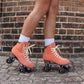 Chuffed Skates peach pink roller skates with brick background