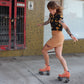 Smiling roller skater wearing Chuffed Skates peach pink roller skates